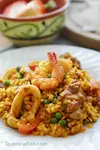 Tasty mixed paella or paella mixta on a plate.