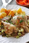 Spanish chicken and broad beans with mushrooms stew on a plate.