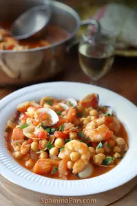 Spanish chickpea and seafood stew on a plate.