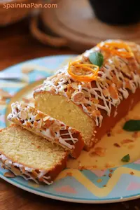 Spanish orange cake loaf with glazing and almond shaves.