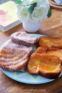 Spanish honey torrijas on a decorative serving plate.