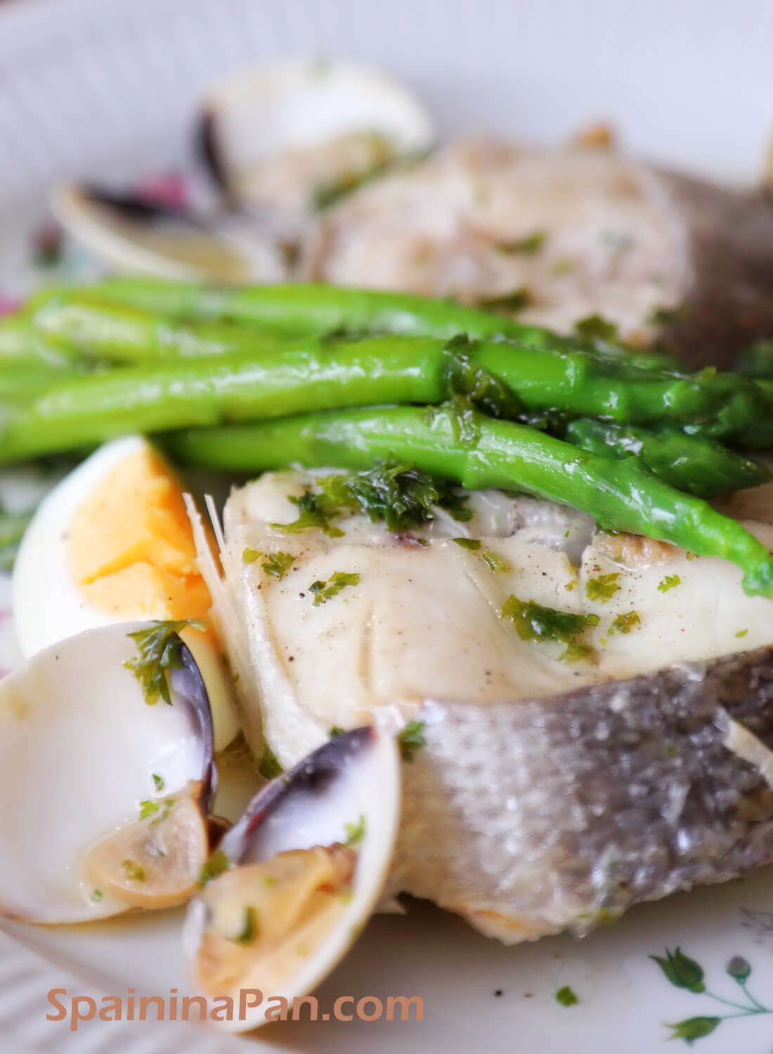 Merluza a la koskera, a Spanish hake and asparagus dish.