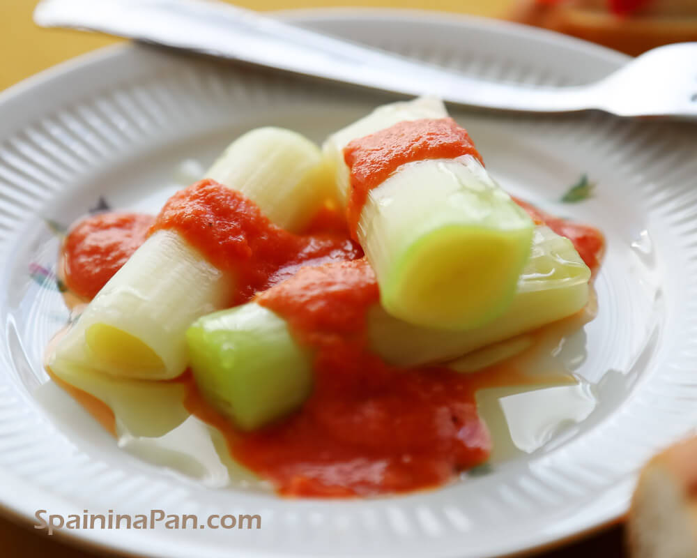 Leek with romesco sauce on a plate. Leek with romesco sauce on a plate.