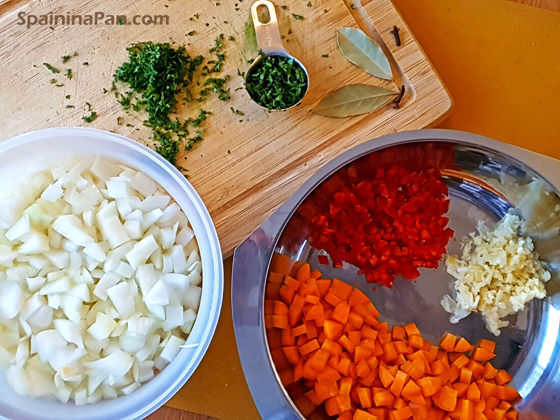 Aromatics for the Spanish spicy beef stew on a cutting board.