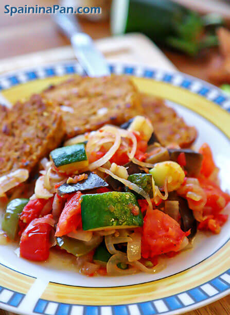 Spanish pisto manchego with meatloaf on a plate.