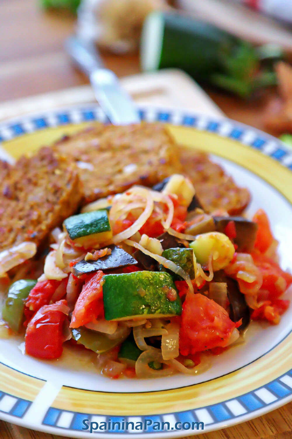 Spanish pisto manchego with meatloaf on a plate.