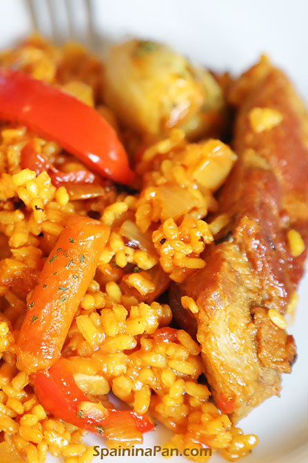 Spanish pork ribs paella on a plate. Spanish pork ribs paella on a plate.