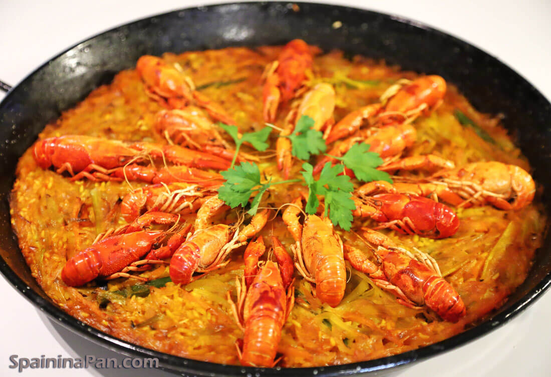Spanish crayfish paella in a pan.