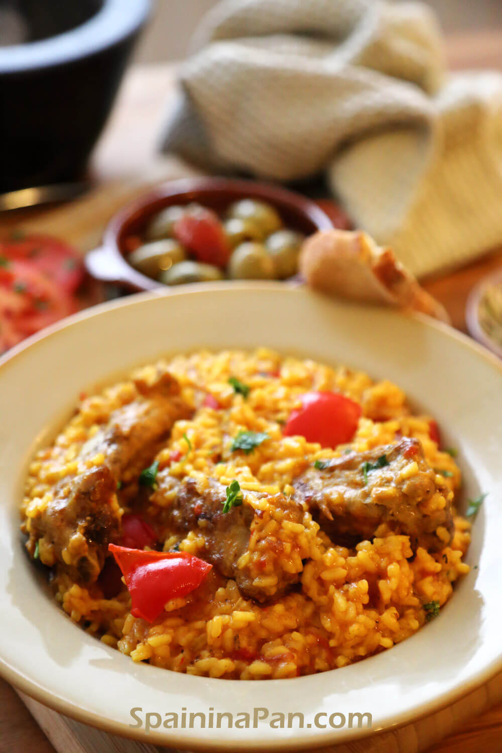 Mellow Spanish rice and pork ribs on a earth plate.