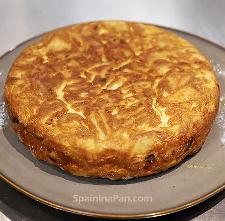 An entire tortilla española on a plate.