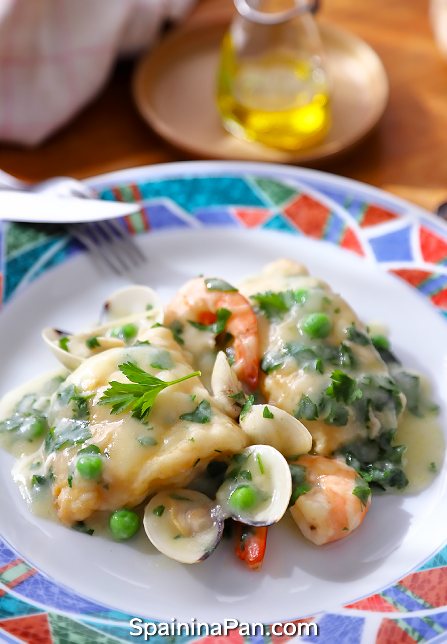 Spanish currito monkfish with sauce on a decorative plate.