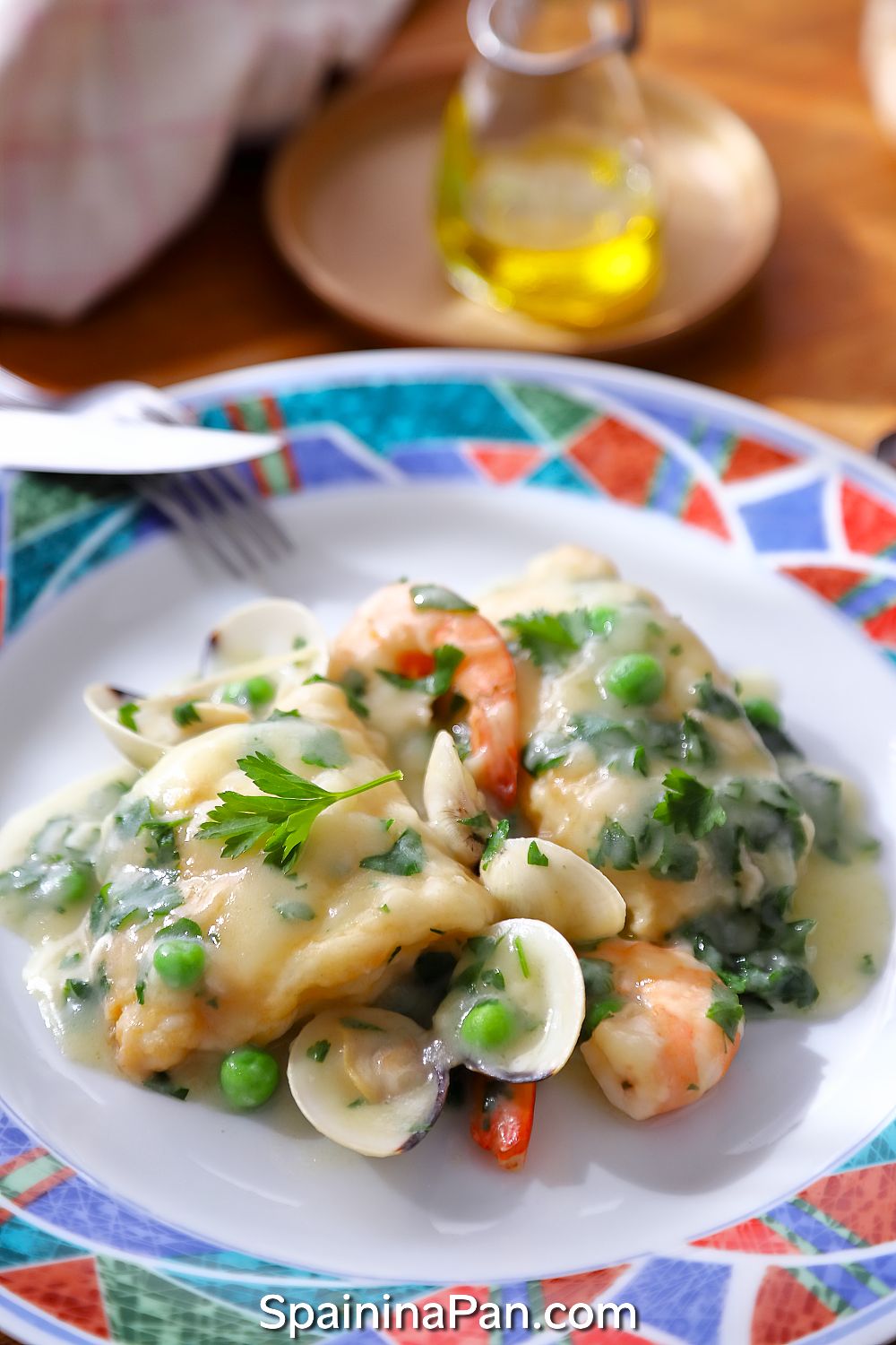 Spanish currito monkfish with sauce on a decorative plate.