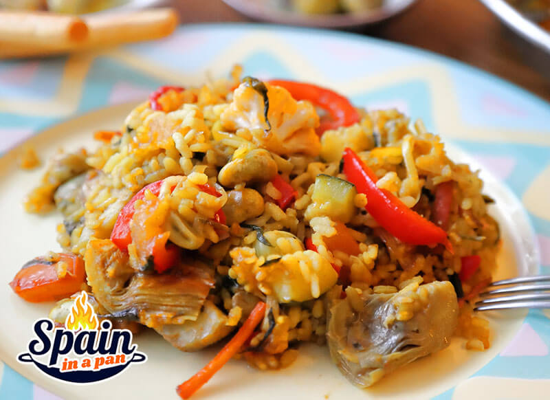 Vegetables paella on a decorative plate.