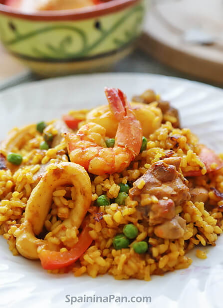 Paella mixta on a white plate.