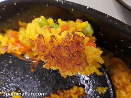 The brown crusty bottom layer from a paella socarrat. The brown crusty bottom layer from a paella socarrat.