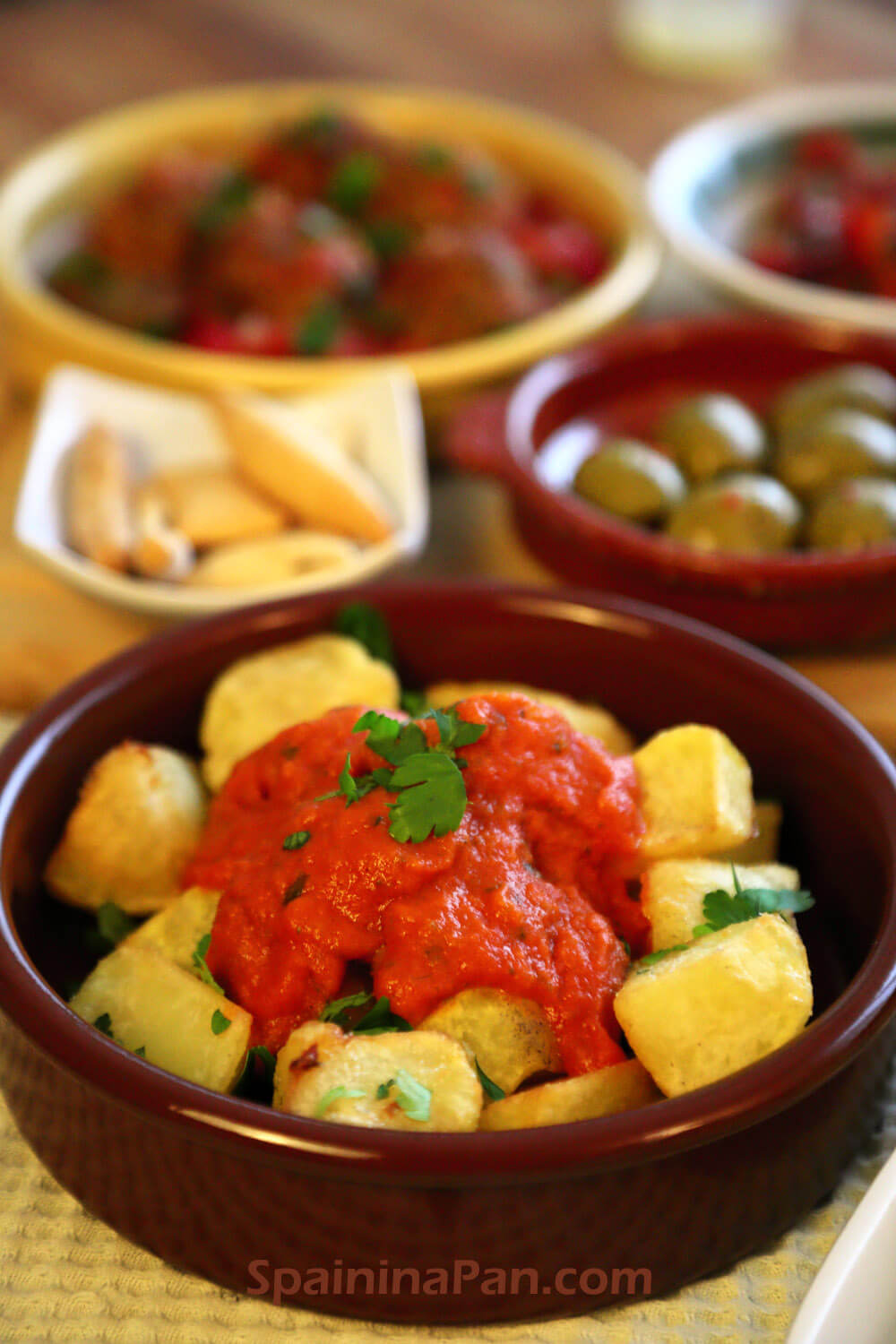 Spanish patatas bravas with salsa brava sauce on a plate.