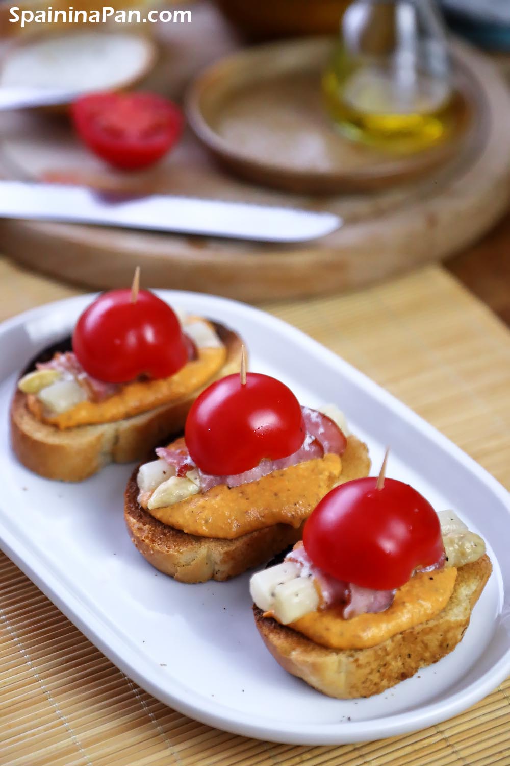 Romesco asparagus pintxos on a ceramic tray.