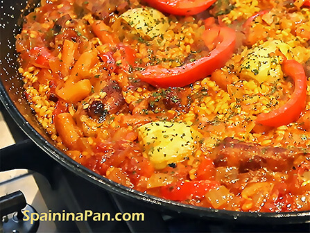 Spanish pork ribs paella in a pan. Spanish pork ribs paella in a pan.
