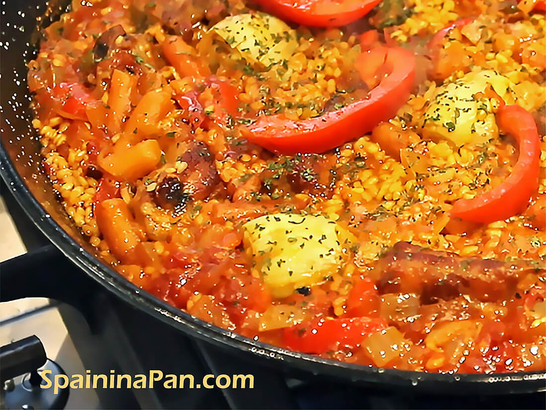 Spanish pork ribs paella in a pan. Spanish pork ribs paella in a pan.