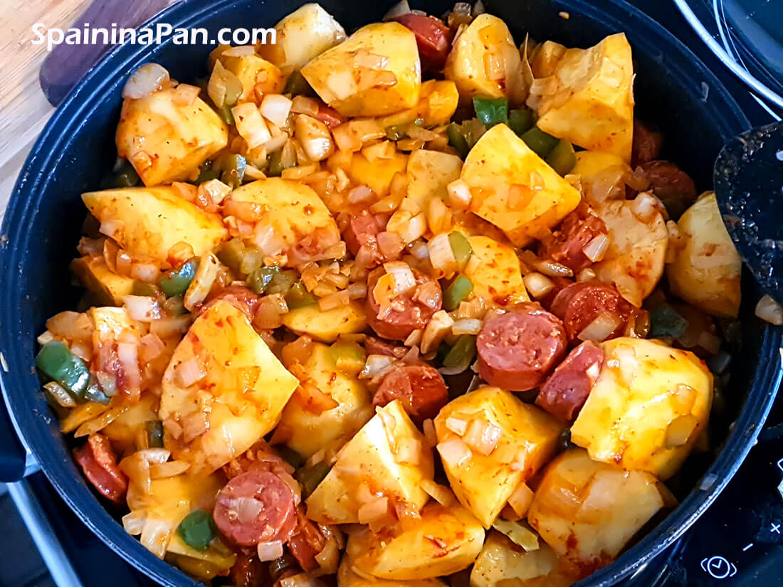 Preparing a Spanish patatas a la riojana.