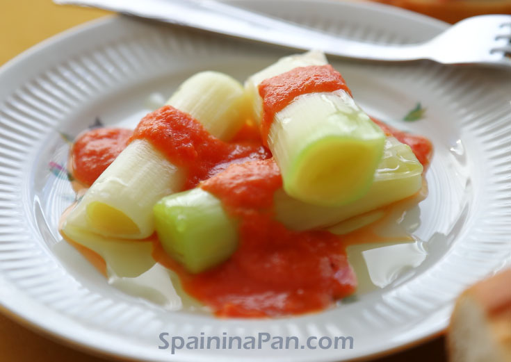 Cooked leek with Spanish romesco sauce on a plate