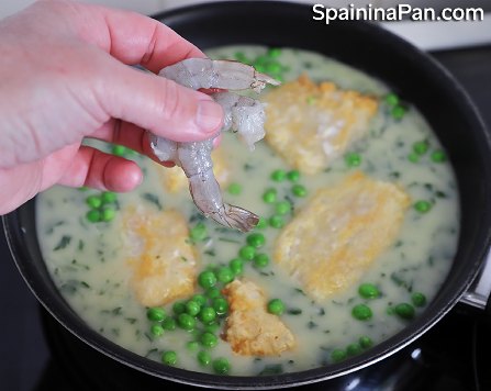 Spanish currito monkfish with sauce in a pan.