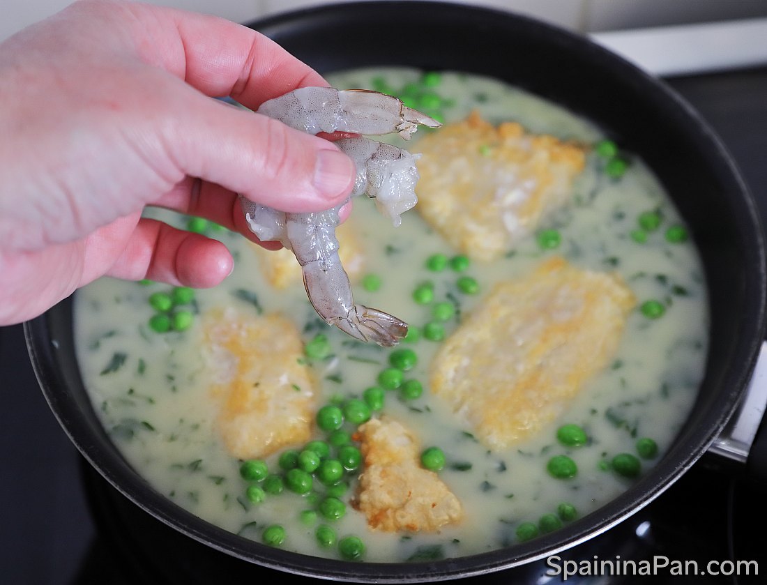 Spanish currito monkfish with sauce in a pan.