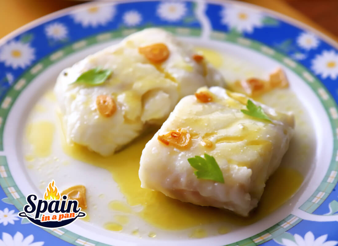 Spanish cod with pil pil sauce on a decorative plate.