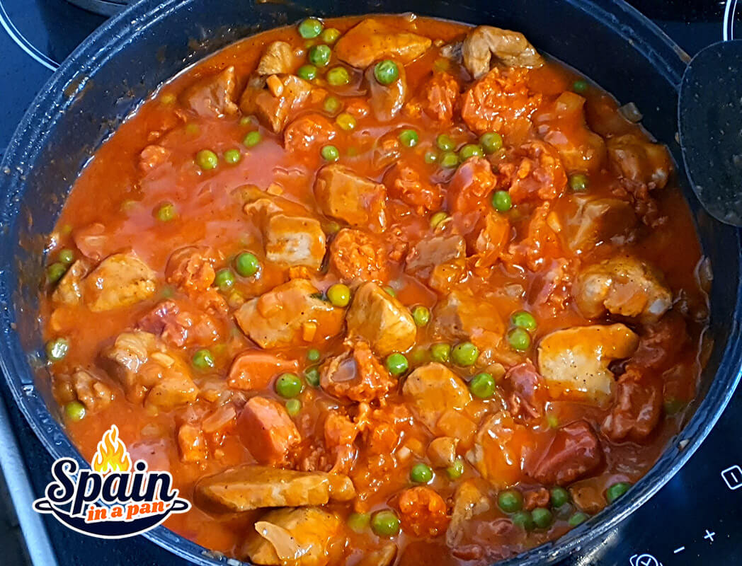 Spanish pork and chorizo stew in a frying pan.