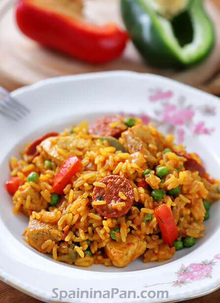 Spanish chicken and chorizo paella on a decorative plate.