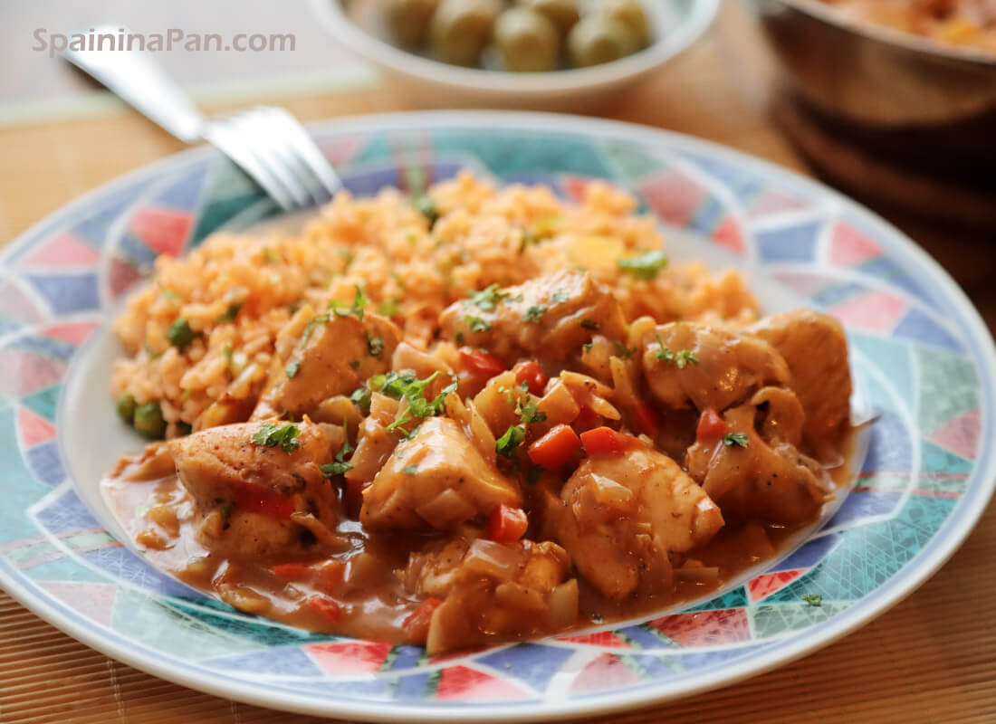 Spanish chicken with orange sauce on a plate. Spanish chicken with orange sauce on a plate.