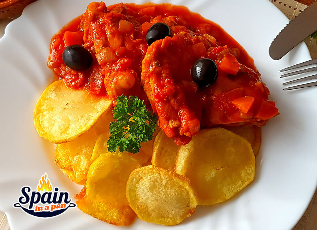 Spanish chicken in a tomato sauce with baked potatoes.