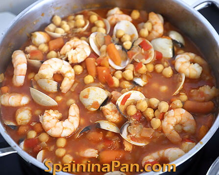 Spanish chickpea and seafood stew on a plate.