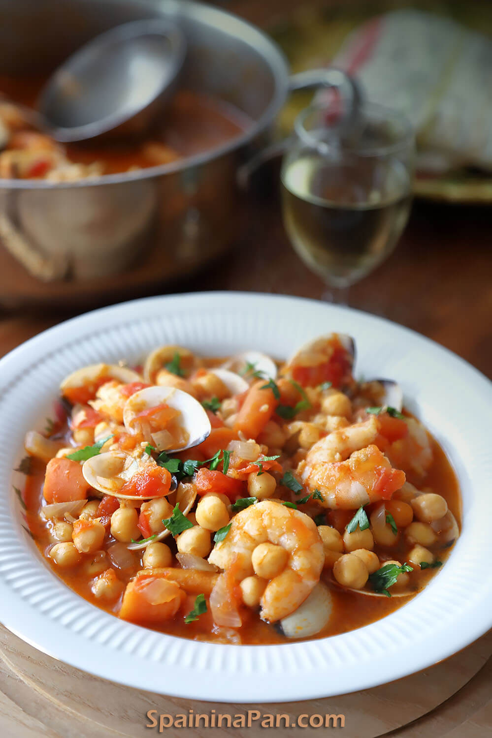 Spanish chickpea and seafood stew on a plate.