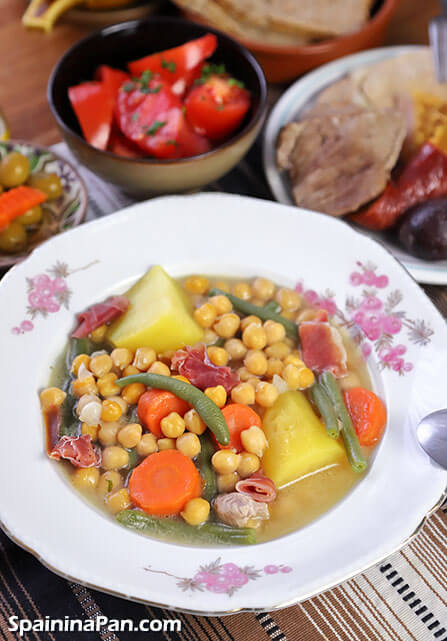 Andalusian cocido stew in a decorative plate with sides.