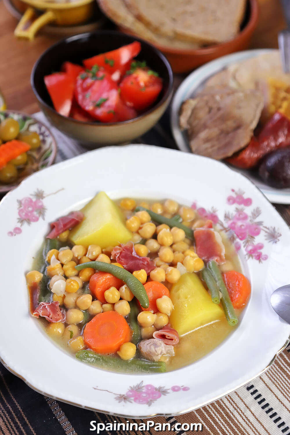 Andalusian cocido stew in a decorative plate with sides.
