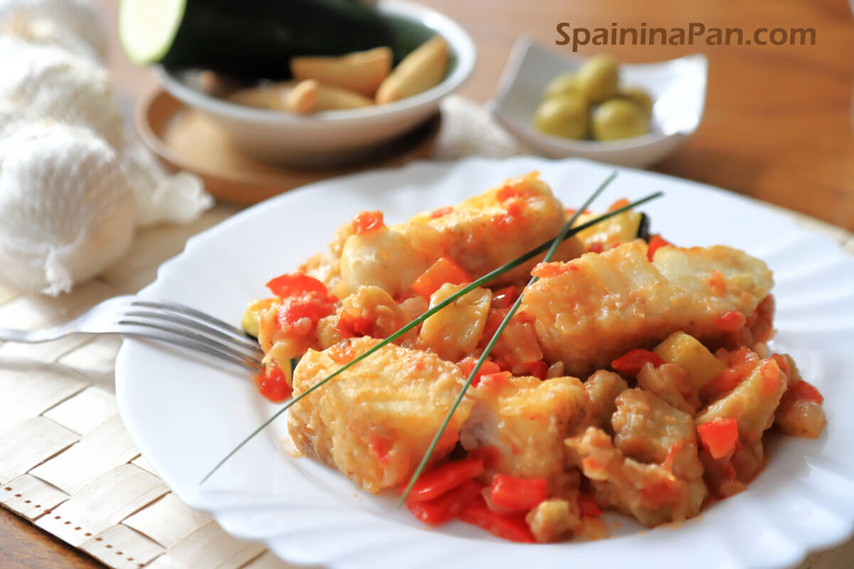 Spanish cod with samfaina sauce on a plate.
