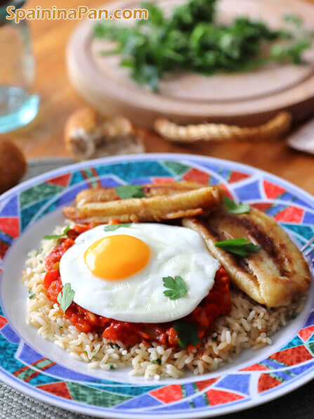 Spanish Cuban rice with banana on a plate.