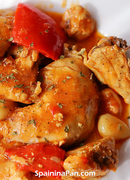 Appetizing Spanish garlic chicken on a tray with sauce.
