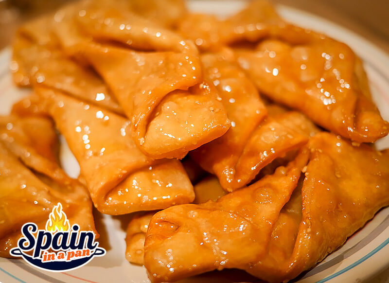 Spanish honey pestiños pastry in a tray.