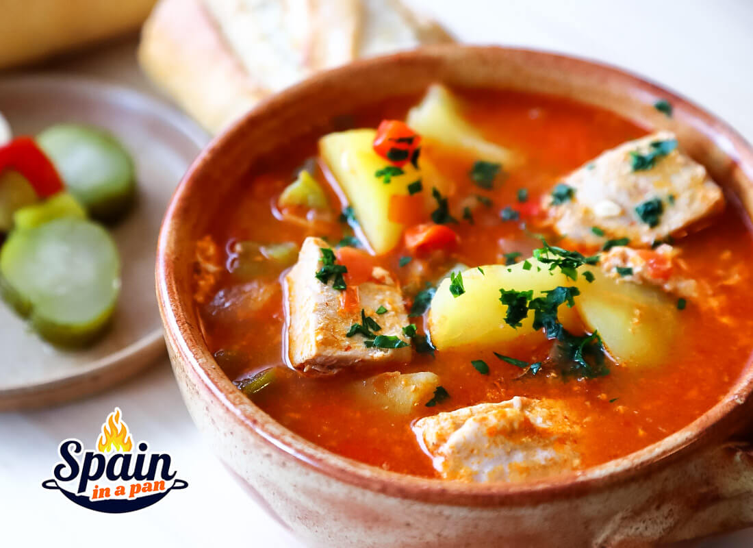 Spanish marmitako tuna potato stew in a bowl with bread.