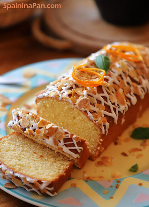Spanish orange cake loaf with glazing and almond shaves.