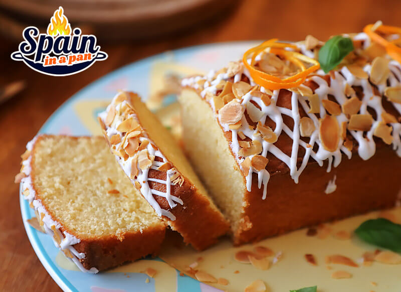 Spanish orange cake loaf with glazing and almond shaves.