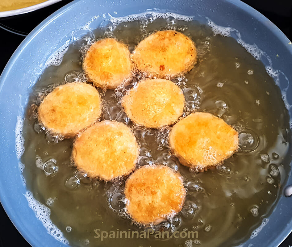 Spanish importancia potatoes frying in a pan.