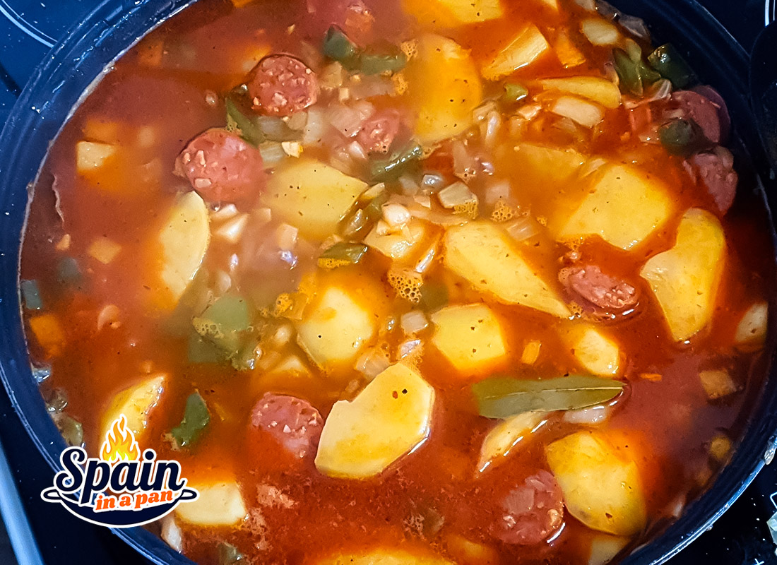 Spanish patatas a la Riojana potato stew simmering in a pan.