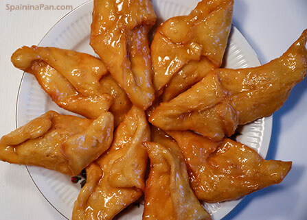 Spanish pestiños pastries on a plate.