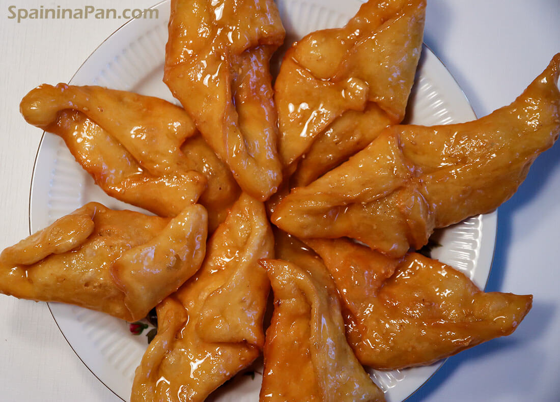 Spanish pestiños pastries on a plate.