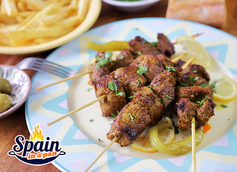 Spanish pinchitos morunos skewers on a plate.