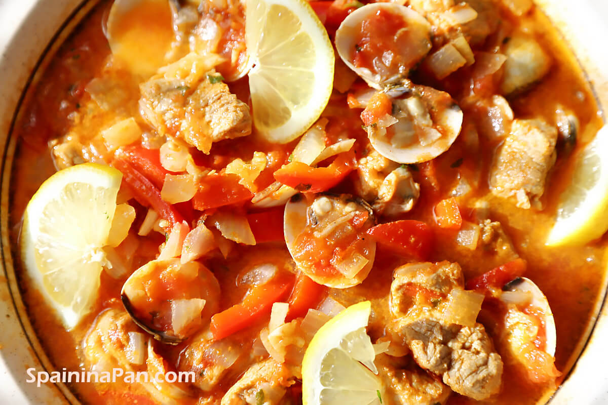 Spanish pork loin with clams stew in a tray Spanish pork loin with clams stew in a tray