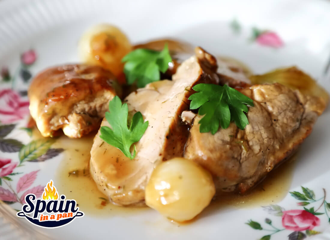 Spanish pork tenderloin with Jerez sauce on a decorative plate.